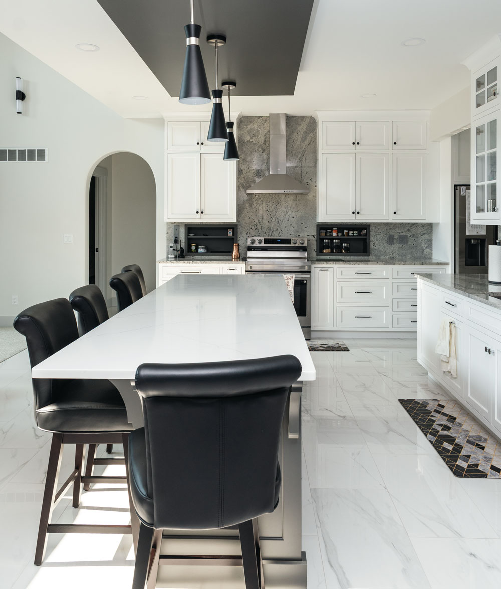 Kitchen interior, with white cabinets and marble flooring